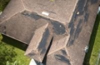 storm-damage-wind-damaged-residential-roof-missing-asphalt-shingles-services-box
